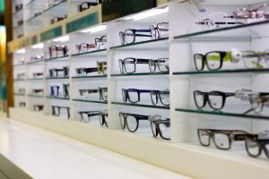 Picking eyeglasses from a frame wall
